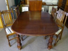 AN EARLY TO MID 20th CENTURY OAK WIND-OUT DINING TABLE with additional leaf and a set of four high