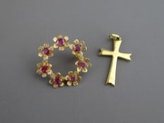 A NINE CARAT GOLD CIRCULAR LEAF BROOCH with seven rubies in floral form (pin missing), 2 grms and