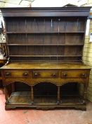 A CIRCA 1820 WELSH OAK POTBOARD DRESSER, with three shelf boarded rack over a two plank