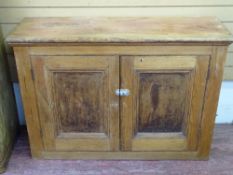 A VINTAGE PINE TWO DOOR HOUSEKEEPER'S CUPBOARD, 82 cms high, 117 cms wide, 40 cms deep