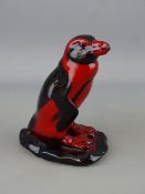 A ROYAL DOULTON FLAMBE MODEL OF A PERUVIAN PENGUIN, printed factory marks to the base with 'Fred