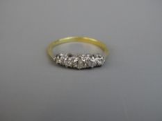 AN EIGHTEEN CARAT GOLD FIVE STONE DIAMOND DRESS RING, the centre stone of visual estimate 0.2
