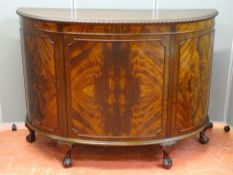 AN EARLY 20th CENTURY MAHOGANY DEMI-LUNE SINGLE DOOR SIDEBOARD with carved edge moulding on ball and