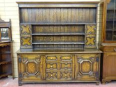 AN EXCELLENT JACOBEAN STYLE OAK DRESSER with three shelf rack and flanking cupboard doors with