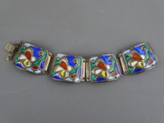 A SILVER & ENAMEL BRACELET BY OYSTEIN BALLE, NORWAY of four linked panels of abstract design with