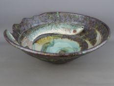 A ROGER COCKRAM 34.5 cms DIAMETER PIERCED STONEWARE BOWL with incised fish decoration, one with head