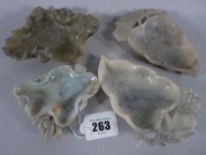 TWO CHINESE CARVED HARDSTONE DISHES and two others to include a well carved lotus leaf example, 10