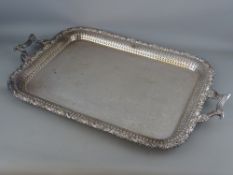 A GOOD SILVER PLATED TWO HANDLED SERVING TRAY with grape vine and swag decorated border and