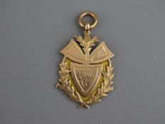 A NINE CARAT GOLD INITIALLED THISTLE PENDANT, 6.8 grms