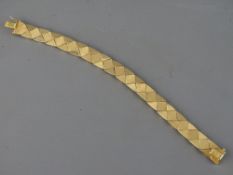 AN ITALIAN EIGHTEEN CARAT GOLD CUBIST BLOCK LINK BRACELET with safety fastener, stamped '750', 23