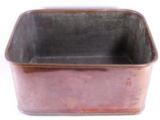 A LARGE ANTIQUE RECTANGULAR COPPER PAN with bronze carry handles, 26 cms high, 55 cms long, 42 cms