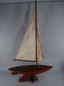 A VINTAGE WEIGHTED KEEL POND YACHT named 'Heather Elf' with original card, box and transportation