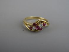 A NINE CARAT GOLD RUBY & DIAMOND CROSSOVER DRESS RING, 2.9 grms, size mid 'O' to 'P'
