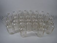 APOTHECARY BOTTLES - Thirty one clear glass ribbed bottles, 3.5 fl ozs (approximately 100 ml), 13.