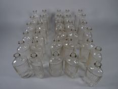 APOTHECARY BOTTLES - Thirty two clear glass ribbed bottles, 3.5 fl ozs (approximately 100 ml), 13.