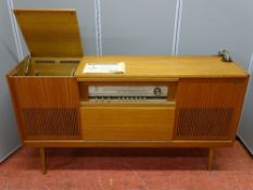 A MID CENTURY GRUNDIG STEREO CABINET with turntable and speakers, 145 cms wide