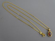 A NINE CARAT GOLD NECK CHAIN with oval garnet pendant, 2.8 grms
