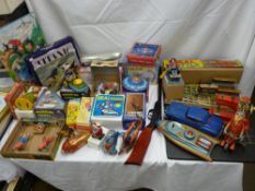 A good selection of vintage and later tin plate clockwork collectables and toys, a pop gun and a