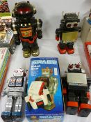 Five various battery operated robots including a modern boxed tinplate example