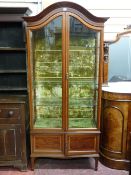 Edwardian mahogany and inlaid china cabinet with swept and domed top, two long doors on tapered