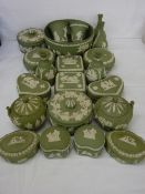 Collection of green Wedgwood Jasperware, mainly pin boxes and vases in near matched pairs with a