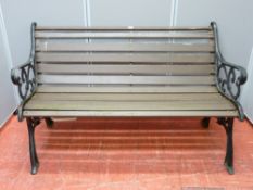 A wooden slatted bench with cast iron ends