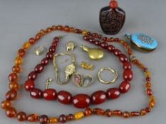 Two amber type sets of beads and a snuff bottle, a Victorian enamel and seed pearl set locket, a