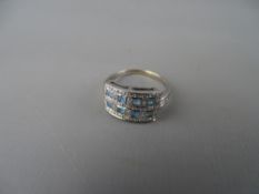 Eighteen carat gold dress ring having eight square topaz stones in an oblong setting with tiny