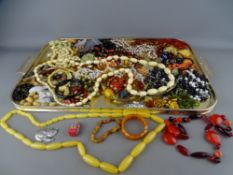 A good tray of vintage and later costume jewellery, necklaces etc, including amber type beads,
