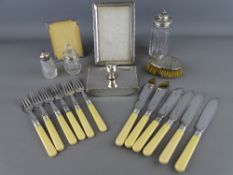 A silver photograph frame, desk blotter and silver topped bottles, a child's brush, a set of EPNS