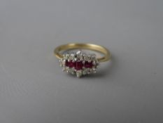 Nine carat gold ruby and diamond cluster dress ring, having three oblong cut centre rubies with