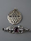Oval silver Celtic style pendant, 4 cms long, 7 grms and a white metal thistle brooch with oval
