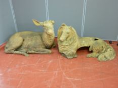 Two early 20th Century terracotta garden figurines of a recumbent deer with glass eyes and a