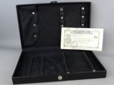 A black leather effect jewellery case containing a 1946 South Australia one schilling and sixpence