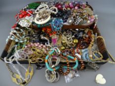 A large quantity of vintage and later costume jewellery displayed on two trays