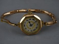 A vintage nine carat gold lady's wristwatch on a nine carat gold expanding bracelet (appears in
