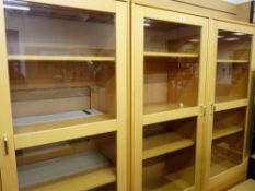 An ultra modern lightwood lounge display system and a small three drawer chest