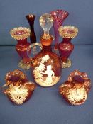Cranberry glass decanter with stopper and a pair of frilly top vases decorated Mary Gregory style, a