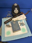 Circa 1950s/60s police helmet, truncheon, handcuffs and whistle on chain, three Masonic aprons and