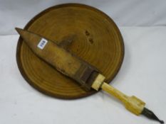 A probably Eastern hide, circular shield and bone handled knife in sheath