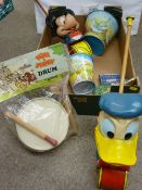Two British made Mickey Mouse and Donald Duck push-along toys, a tinplate Tom & Jerry drum, two
