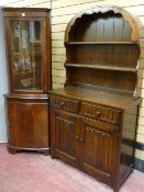 A glass top reproduction corner cabinet and a Priory style dresser