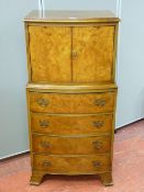 Reproduction walnut two door cabinet on chest, 109 cms high, 56 cms wide maximum, 35 cms deep