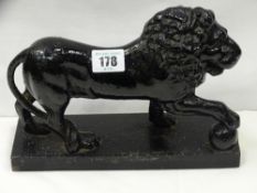 A good Victorian cast iron standing lion doorstop, 17 cms high, 23.5 cms long