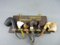 Collection of antique tobacco pipes including Meerschaum examples with amber type mouth pieces