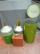 Two vintage oil containers in tin storage drums and a vintage petrol can with screw-on lid