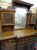 Edwardian breakfront mirror back sideboard having a carved front, four drawers and four cupboard