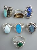 Parcel of seven silver and white metal dress rings, majority well decorated with blue stones, 49