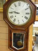 Victorian walnut cased pendulum wall clock, the dial set with Roman numerals, 79 cms high, 43 cms