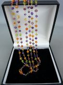 Eighteen carat gold triple strand necklace of small precious stones, 21 grms